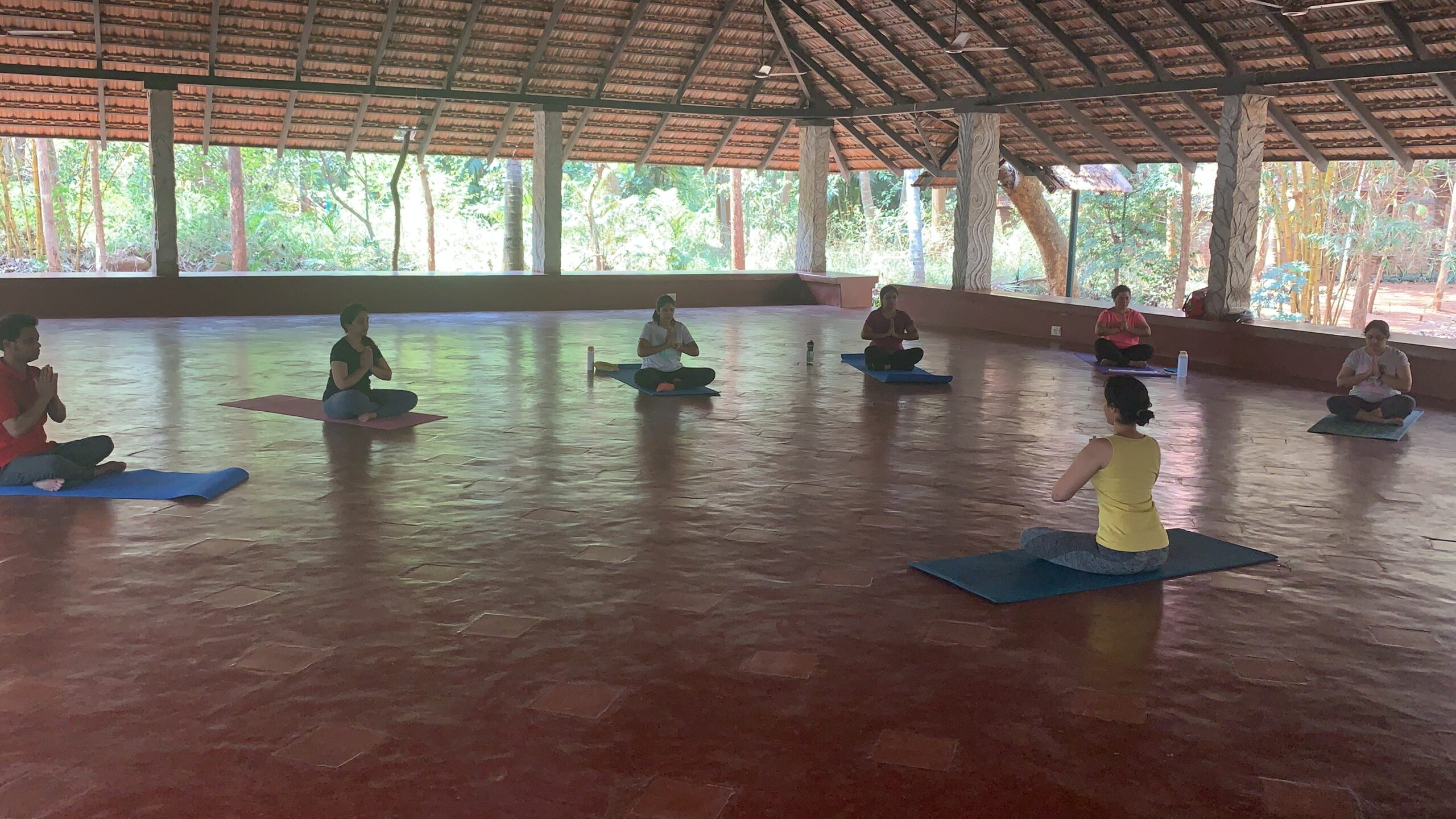 Group meditation in open-air retreat pavilion — Chittamandara retreats