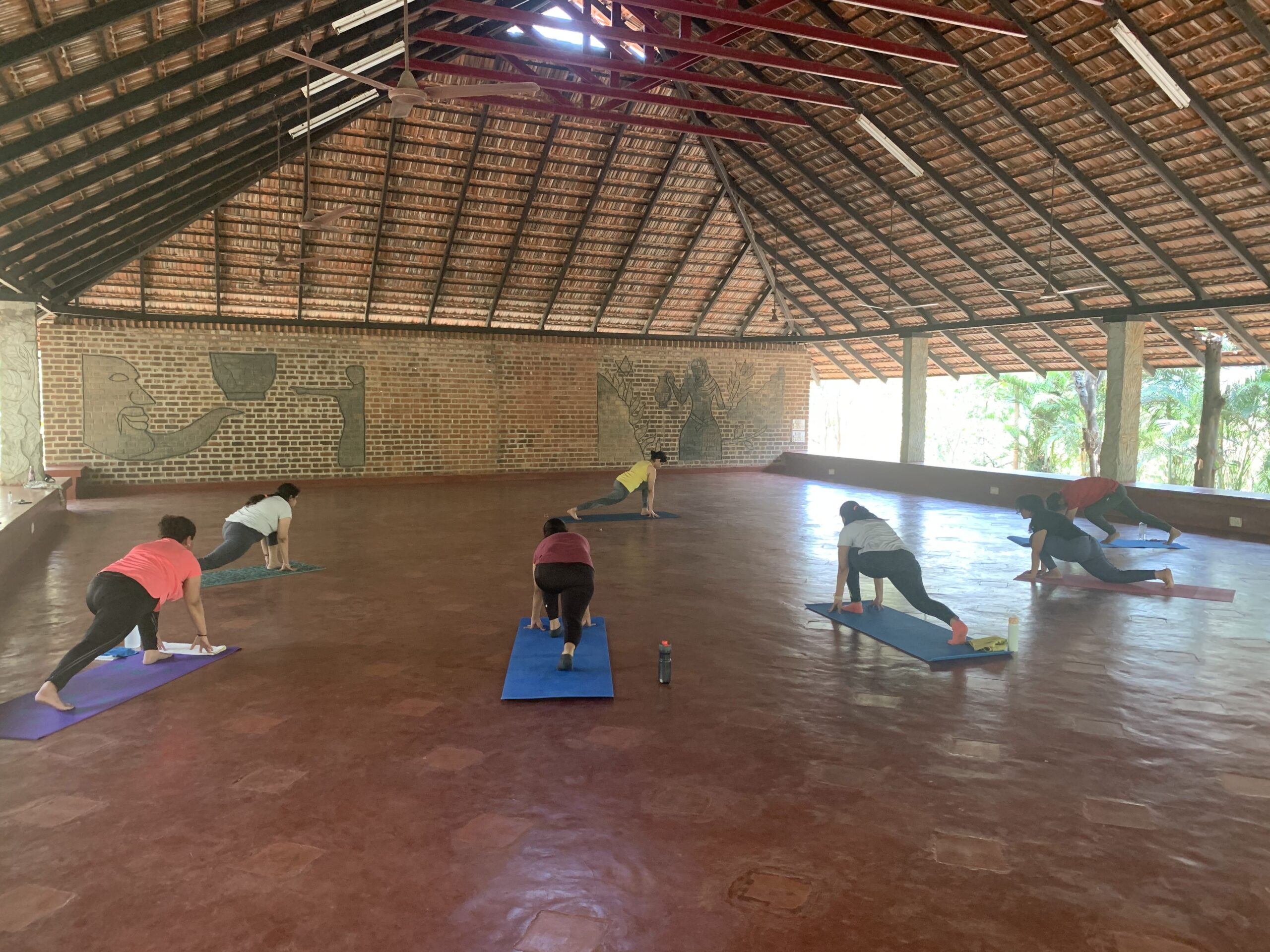 Group yoga in beautiful open thatched hall — Chittamandara retreat programme